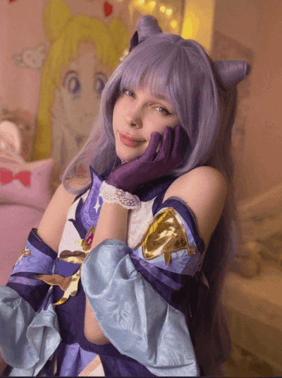 Cosplayer with lavender wig and cat-ear headband in a purple fantasy outfit, resting her cheek on her gloved hand in a pastel-styled room.